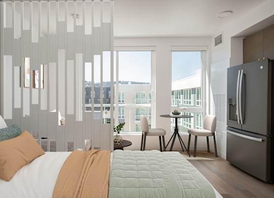A modern bedroom with a large bed and a view of the city.