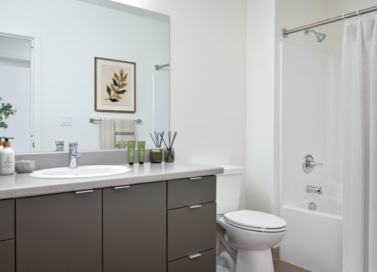a bathroom with white walls and a white bathtub with a shower curtain