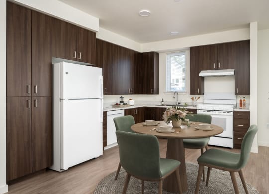 a kitchen and dining room with a table and chairs