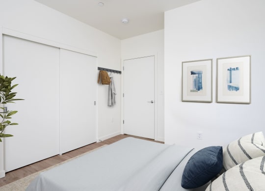 a bedroom with a large bed and two white closets