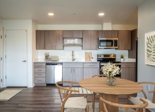 a kitchen and dining room with a wooden table and chairs