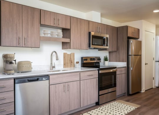 a kitchen with stainless steel appliances and wooden cabinets