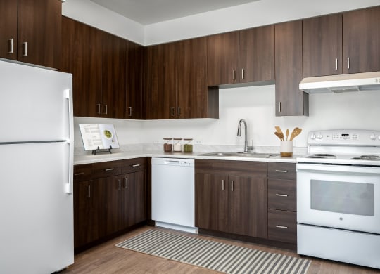a kitchen with white appliances and wooden cabinets