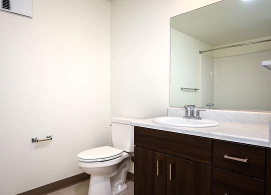 an empty bathroom with a toilet and a sink