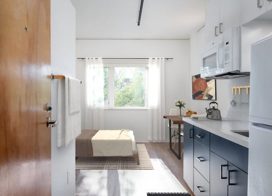a small kitchen with a table and a window