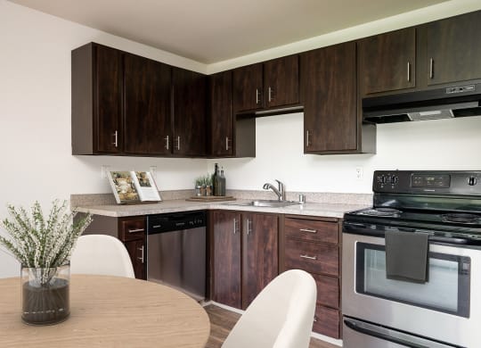 our apartments offer a kitchen and dining area with a table