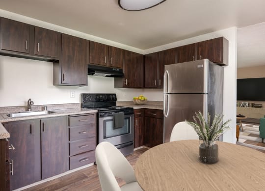 a kitchen with stainless steel appliances and a wooden table