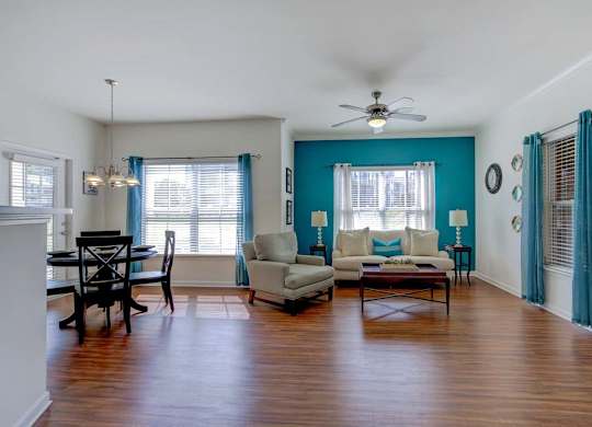 A living room with a dining table and chairs at Ethan Pointe Apartments, Greensboro, NC
