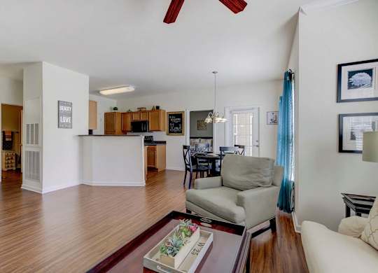 A living room with a grey couch and a coffee table. at Ethan Pointe Apartments, North Carolina, 27215