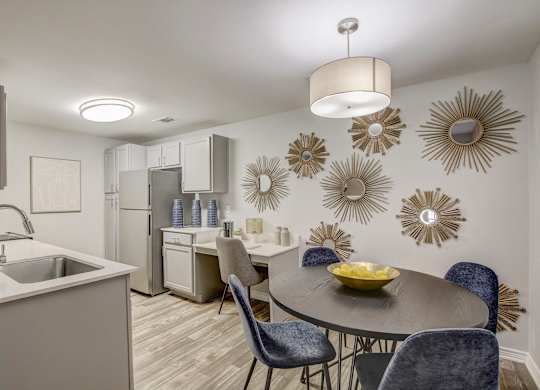 A modern kitchen with a dining table set for four.