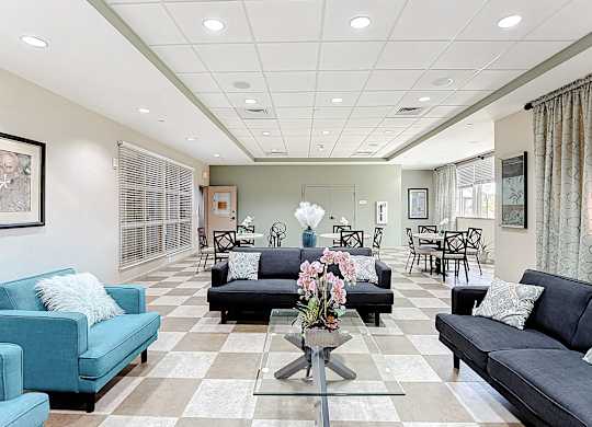 A living room with a blue couch and a coffee table.