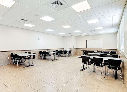 A conference room with tables and chairs.