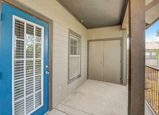 A blue door with white window blinds is on the left.