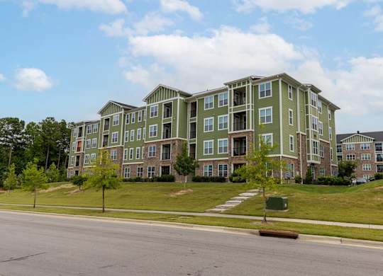 A large apartment complex with multiple buildings and green lawns at Foxwood Apartments, Raleigh-Durham, NC, 27616