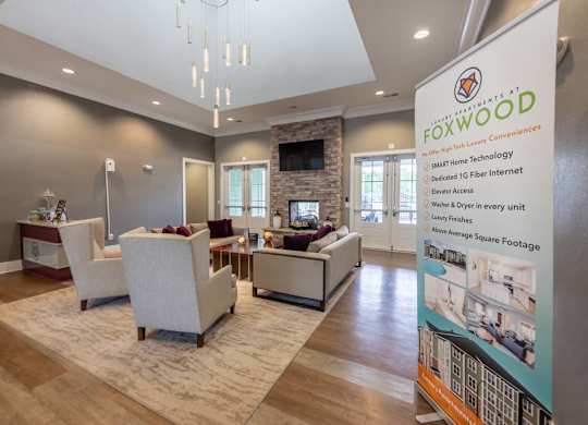 A living room with a sign that says Foxwood in front of it at Foxwood Apartments, Raleigh-Durham, NC, 27616