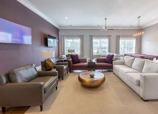 A living room with a white couch and a wooden coffee table at Foxwood Apartments, North Carolina