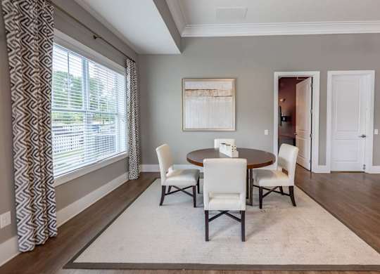 A dining room with a table and chairs at Foxwood Apartments, Raleigh-Durham, NC