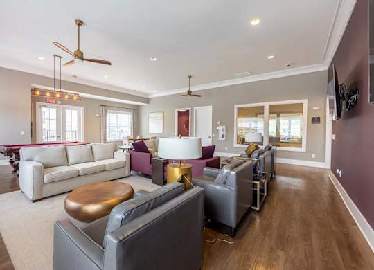 A living room with a white couch and a wooden coffee table at Foxwood Apartments, North Carolina