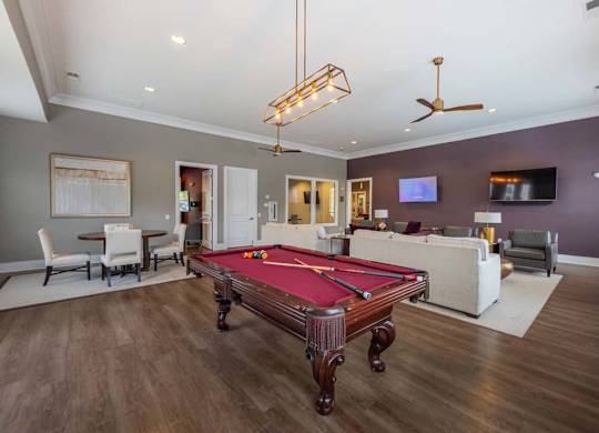 A room with a pool table and a television at Foxwood Apartments, Raleigh-Durham
