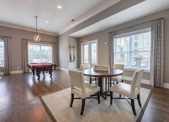 A dining room with a table set for four at Foxwood Apartments, North Carolina, 27616