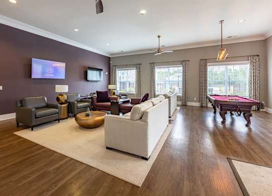 A living room with a white couch and a wooden floor at Foxwood Apartments, North Carolina, 27616