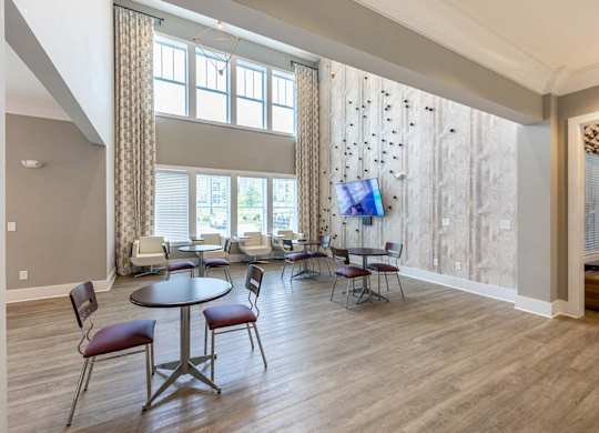 A room with a table and chairs in front of a large window at Foxwood Apartments, Raleigh-Durham, NC, 27616