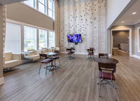 A modern living room with a television and a dining table at Foxwood Apartments, North Carolina