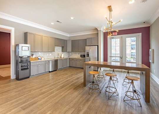A kitchen with a bar stool and a bar table at Foxwood Apartments, Raleigh-Durham, North Carolina