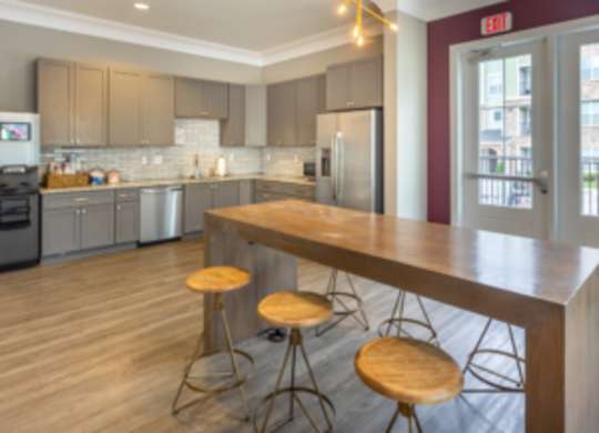 A kitchen with a bar area and a wooden counter at Foxwood Apartments, North Carolina, 27616