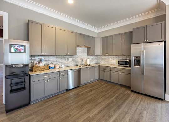 A kitchen with wooden floors and stainless steel appliances at Foxwood Apartments, Raleigh-Durham, NC
