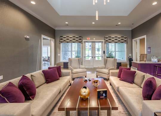 A living room with a large couch and a coffee table at Foxwood Apartments, North Carolina
