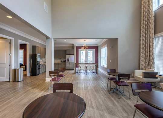 A large open living room with a dining table and chairs at Foxwood Apartments, North Carolina, 27616
