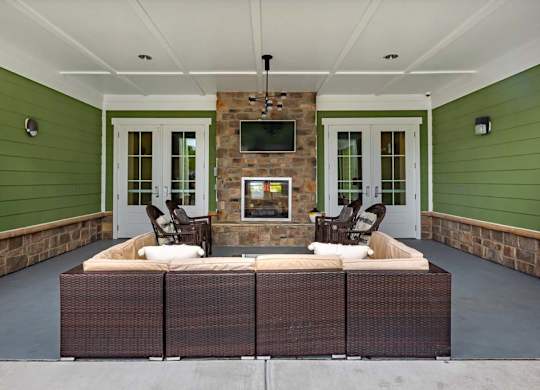 A patio with a fireplace and seating area at Foxwood Apartments, Raleigh-Durham