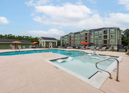 A large swimming pool with a slide in front of a building at Foxwood Apartments, Raleigh-Durham, North Carolina