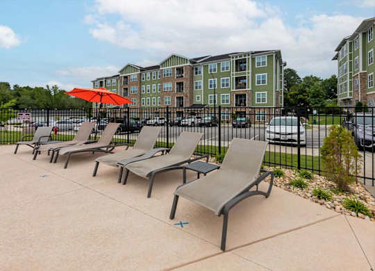 A row of grey chairs are lined up on a concrete area at Foxwood Apartments, Raleigh-Durham, NC, 27616