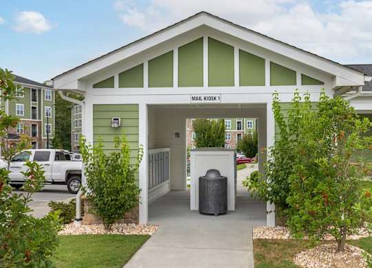 A green and white building with a sign at Foxwood Apartments, North Carolina
