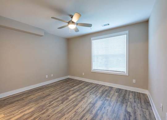 A room with a ceiling fan and a window with blinds at Foxwood Apartments, Raleigh-Durham, NC, 27616