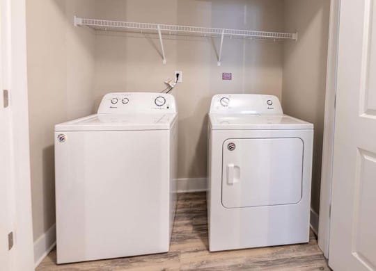 A small laundry room with a washer and dryer at Foxwood Apartments, North Carolina