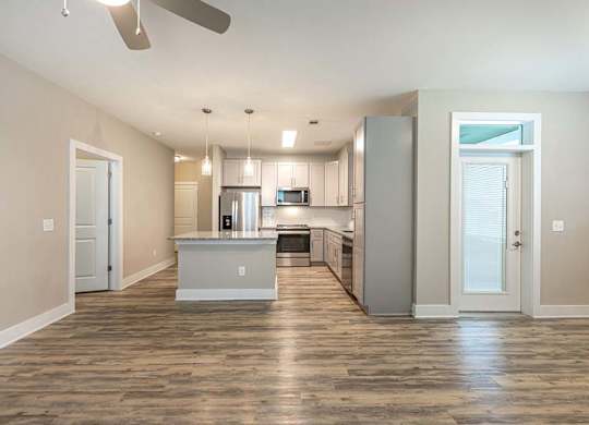 A spacious kitchen with a center island and a fan on the ceiling at Foxwood Apartments, North Carolina, 27616