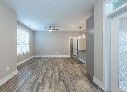 A room with a ceiling fan and wood flooring at Foxwood Apartments, Raleigh-Durham, NC
