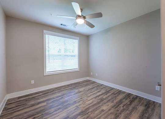 A room with a ceiling fan and a window with blinds at Foxwood Apartments, Raleigh-Durham, 27616