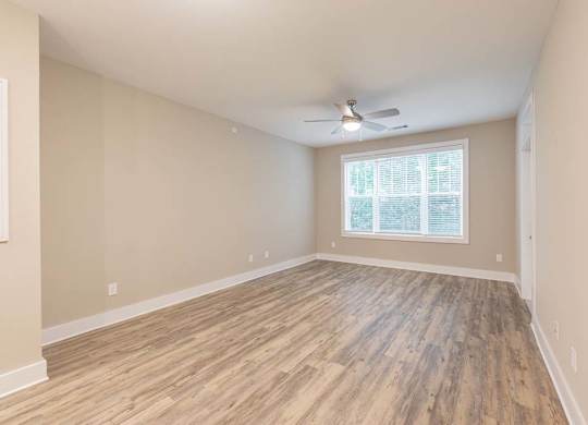 A room with wooden flooring and a ceiling fan at Foxwood Apartments, Raleigh-Durham, 27616