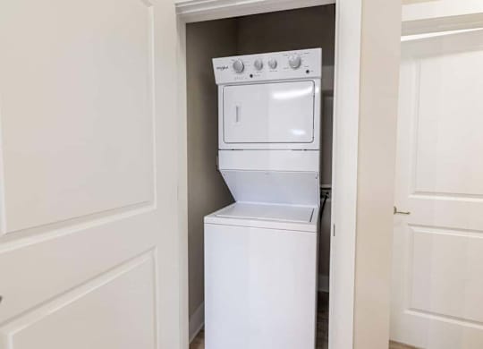 A white oven and stove top are in a small kitchen at Foxwood Apartments, Raleigh-Durham, NC