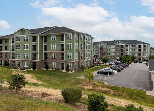 A large apartment complex with a parking lot in front at Foxwood Apartments, Raleigh-Durham, NC, 27616