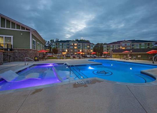 A swimming pool with a blue light in the middle of it at Foxwood Apartments, Raleigh-Durham, 27616