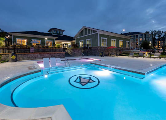 A pool with a diamond logo in the middle of it at Foxwood Apartments, Raleigh-Durham