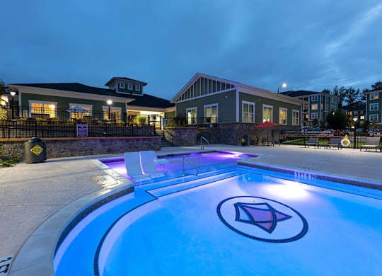 A swimming pool with a logo in the middle of it at Foxwood Apartments, Raleigh-Durham, NC