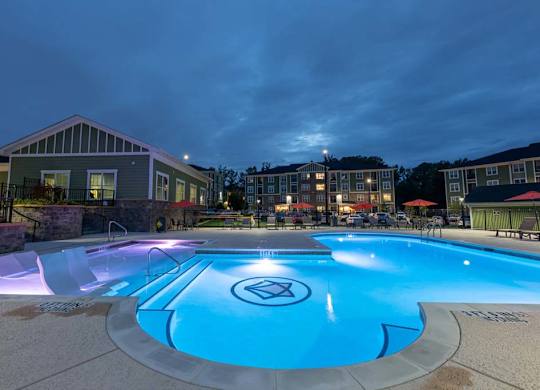 A swimming pool with a logo in the middle of it. at Foxwood Apartments, Raleigh-Durham, NC, 27616