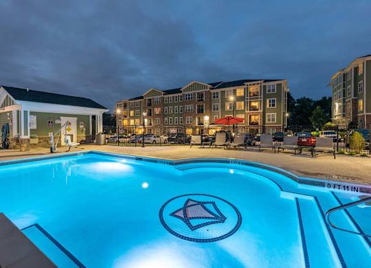 A swimming pool with a diamond logo in the middle of it. at Foxwood Apartments, Raleigh-Durham, NC