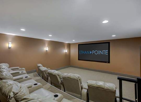 A row of white recliner chairs are lined up in a room with a wall that says Ethan Pointe at Ethan Pointe Apartments, Greensboro, NC, 27215